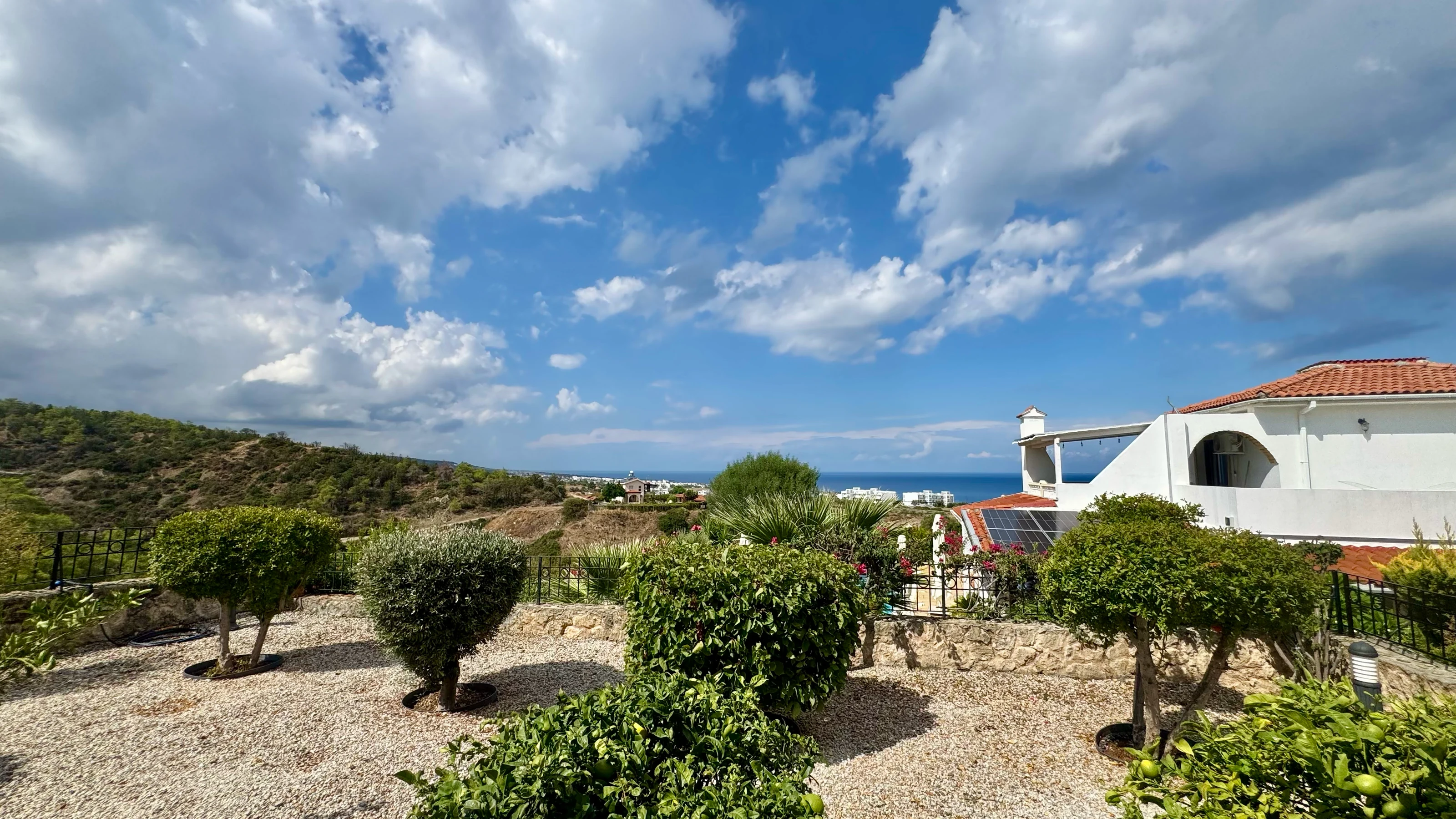 Established fruit garden with the natural valley and Mediterranean Sea on the horizon