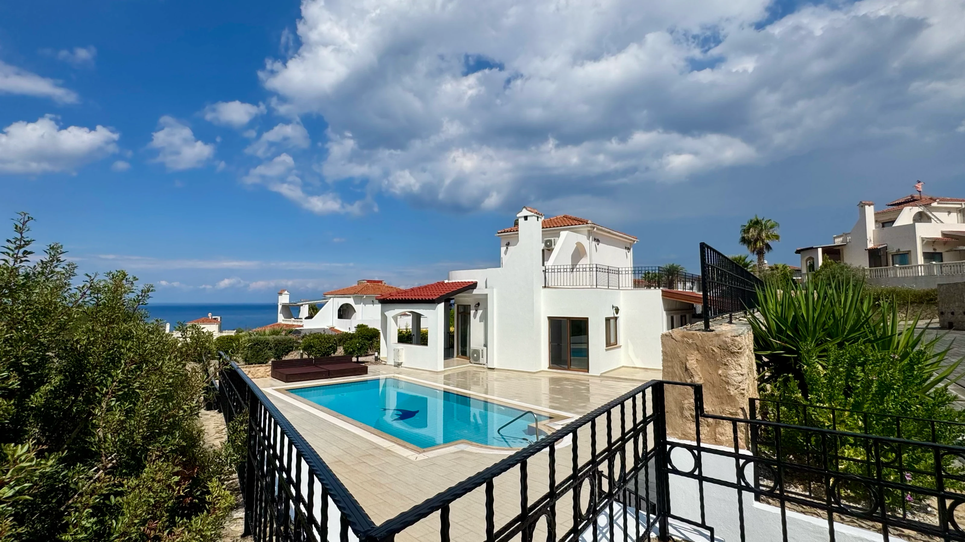 Second villa with its turquoise private pool and the Mediterranean Sea in the distance